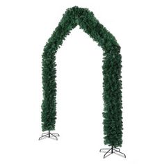 a long green garland with metal stand on the side and white backdrop in the background