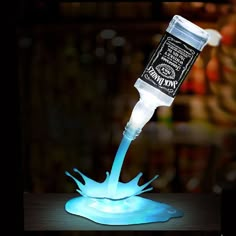 a blue liquid pouring out of a bottle