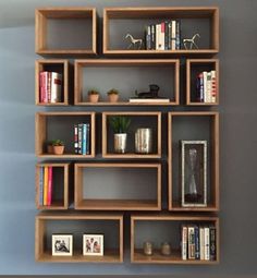 the bookshelf is made out of wooden boxes