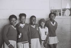 black and white photograph of four girls in school uniforms