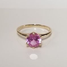 "Thanks for shopping our vintage estate store. We tend to sell well below wholesale and truly hope you enjoy all of our items. Many of the items are one of a kind, so please enjoy scrolling through the pictures and hopefully something will catch your eye. Brown spots are from camera or reflections. Estate 10k yellow gold created pink topaz 2ct pink or ice cocktail ring. Round cut stunning gem and no scratches on the gem. Gem is testing sapphire but may be topaz as well. Ring size: 8.25 Setting:  8mm 3/8\" Gem:  8mm 2cts Band Width: 2mm Weight: 2.61 grams Sweet ring, one that you will love. Marked 10k." Classic Pink Topaz Ring For Anniversary, Classic Topaz Birthstone Ring With Round Band, Classic Pink Topaz Ring With Prong Setting, Classic Topaz Ring With Birthstone In Round Band, Classic Pink Gemstone Birthstone Ring, Classic Pink Birthstone Ring, Pink Birthstone Ring In Classic Style, Classic Solitaire Amethyst Ring, Classic Pink Sapphire Ring In 14k Gold