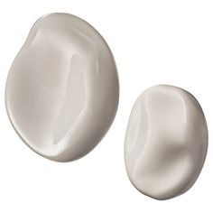 two white round objects on a white background