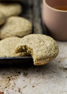 some cookies are on a plate with a cup of tea