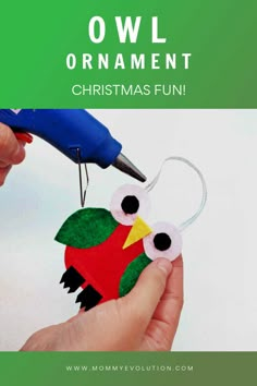 an owl ornament is being made with construction paper and scissors to make it look like