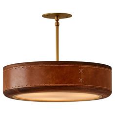 a light fixture with a brown leather finish on the bottom and gold trim around it