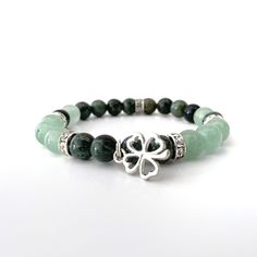 "You will receive one (1) Green Aventurine and Kambaba Jasper energy bracelet with Lucky Clover silver charm, Swarovski bead spacers, infused with Usui Reiki energy. These bracelets are made from 8mm green aventurine and kambaba jasper polished beads, are stretchable, and fit S/M wrists (fit up to 7-7.25\" wrists comfortably.). The model shown in the photo is a small wrist, size 6\". Known as a lucky stone, a Green Aventurine Energy Bracelet can bring opportunity to your door. For those who are Cheap Aventurine Beaded Bracelets As Gifts, Cheap Green Bracelets With Gemstone Beads, Cheap Green Beaded Charm Bracelet, Cheap Adjustable Green Beaded Bracelets, Unique Green Beaded Bracelets, Luxury Adjustable Green Beaded Bracelets, Affordable Green Casual Crystal Bracelet, Casual Green Crystal Bracelet, Cheap Casual Green Bracelets