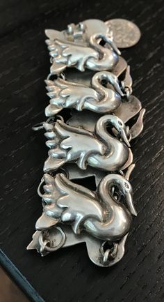 "A rare vintage Mexican sterling repousse Swan bracelet.  Condition I see no problems, box claps works.  Length 7 1/1\", width 1 1/8\", wt. 42.7 grams.  Repousse much more difficult to create than casting, It's A skill I never achieved when silversmithing.  I love good bird jewelry-I raised many birds in outdoor aviaries up until my age made it to difficult.  Birds -mother natures lovely creatures of flight.  The bracelet brings to mind Lisa Vanderpumps pet swans-always a joy see.  The mark is e Vintage Hallmarked Sterling Silver Bracelet In Antique Silver, Antique Sterling Silver Bracelet Formal Stamped 925, Antique Sterling Silver Bracelet Stamped 925 For Formal Occasions, Vintage Silver Carved Jewelry, Vintage Carved Silver Jewelry, Antique Silver Hallmarked Bracelets, Antique Sterling Silver Bracelet Stamped 925, Antique Hallmarked Sterling Silver Bracelet, Victorian Sterling Silver Hallmarked Bracelet