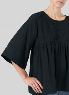 Pleated Relaxed Fit Top For Work, Workwear Pleated Tops With Relaxed Fit, Relaxed Fit Pleated Top For Work, Chic Blouse With Pintucks, Chic Pleated Tops For Work, Chic Pleated Short Sleeve Tops, Relaxed Fit Tops With Pleated Sleeves For Daywear, Summer Relaxed Fit Top With Pintucks, Spring Pleated Workwear Top