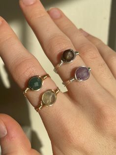 These stunning rings make the perfect promise rings, friendship rings, Mother's day rings or a special gift to self✨ Product details: each ring is made with your choice of silver or gold tarnish resistant wire and four different faceted crystals to choose from - black lace agate, indian agate, fluorite, and amethyst!   All rings are wire wrapped by hand with lots of love and come in US sizes 2-16!  Gift Wrapping: All rings are wrapped up in beautifully designed organza bags - you may choose to include a gift message for you loved one and i will place it in the bag :) ✨Healing Properties✨ Amethyst: a natural tranquiliser, it relieves stress and strain, soothes irritability, balances mood swings, dispels anger, rage, fear and anxiety. Indian Agate: said to promote strength, courage, and prot Adjustable Crystal Ring With Round Band For Promise, Adjustable Round Stone Rings For Gifts, Adjustable Round Stone Ring For Gift, Dainty Wire Wrapped Rings For Gifts, Dainty Wire Wrapped Rings As Gift, Unique Stackable Crystal Ring As Gift, Unique Stackable Crystal Ring For Gift, Adjustable Gemstone Midi Rings With Round Band, Adjustable Crystal Toe Ring For Promise