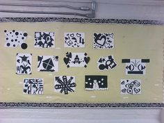 a bulletin board covered in black and white paper cut out to look like abstract art