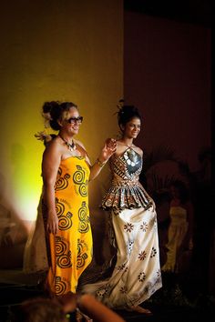 two women standing next to each other on a runway