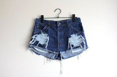 Levi's 557 denim shorts*Classic high waisted fit*Dark blue denim*Ripped, frayed and a bit cuffed*Handmade - this makes them one of a kindSize: Small / W29 from tagMeasurements (centimeters and inches)Waist: 74 cm / 29 inchesHips: 90,5 cm / 35,5 inchesRise: 31 cm / 12,25 inchesInseam: 3 cm / 1 inchesTake a look at other denim shorts from my shop:https://www.etsy.com/shop/sisudenimstore?section_id=21382979Sisu Denim is a part of Sisu Vintage Store, which you can find here:sisuvintagestore.etsy.com Distressed Dark Wash Jean Shorts, Dark Wash Distressed Jean Shorts, Grunge High Rise Ripped Shorts, Dark Wash Ripped High Waist Shorts, Dark Wash Denim Grunge Jean Shorts, Grunge Dark Wash Denim Jean Shorts, Grunge High Waist Ripped Shorts, Ripped Dark Wash Denim Jean Shorts, Ripped Dark Wash Denim Shorts