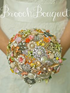 a bridal bouquet is shown with pearls and other jeweled items in it's center