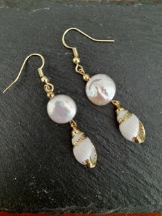 These beautiful earrings are made from real gold plated seashells and Baroque Pearls. The seashells are around 18mm long, Baroque Pearl  12mm, ear-wires are gold filled. Each item is carefully packaged in a beautiful jewellery box ready as a gift. If you would like to add a personalized note with your order, just write a note at checkout and I will send a small card with your gift to the recipient. If you need a bigger quantity or any customized jewellery for your very special occasion (birthdays, weddings, bridal showers or any other event), please send me a message and I'll be glad to help. Elegant Pearl Drop Mother Of Pearl Shell, Elegant Mother Of Pearl Shell With Pearl Drop, Shell-shaped Pearl Charm Earrings As Gift, Elegant Gold Shell With Pearl Charm, Yellow Gold Pearl Drop Earrings With Mother Of Pearl, Yellow Gold Pearl Drop Earrings In Mother Of Pearl, Gold Shell-shaped Clip-on Earrings, Gold Shell Dangle Earrings, Elegant Shell Dangle Earrings