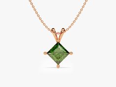 This necklace showcases a single magnificent emerald, celebrated for its rich green color and historical symbolism. Emeralds are often associated with qualities such as rebirth, growth, and fertility. The "double bail" design provides balance and elegance to the pendant, ensuring it hangs gracefully from the chain. The princess cut is characterized by its sharp, square or rectangular shape with pointed corners, which enhances the emerald's natural beauty and brilliance. Classic Emerald Pendant Necklace With Diamond Cut, Classic Green Emerald Necklace In 14k Gold, Classic Diamond Cut Emerald Pendant Necklace, Classic Emerald Diamond Cut Pendant Necklace, Classic Diamond Cut Necklace For May Birthstone, Green May Birthstone Necklace In Fine Jewelry Style, Timeless Emerald Pendant Necklace Gift, Formal Emerald Birthstone Pendant Necklace, Green Fine Jewelry Necklace For May Birthstone