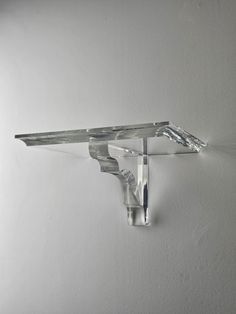 a glass shelf mounted on the wall