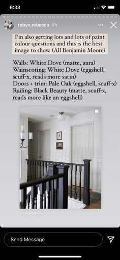 a white room with black railings and pictures on the wall