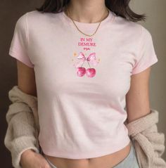 🎀 In My Demure Era baby tee fitted T shirt, Coquette Aesthetic girly baby tee, 90s Y2K crop tshirt, Women's top, pink and cherries crop top 🍒 Youth Size T-shirt, perfect "baby tee" fit (Gildan 5000B) ✨ 100% mid-weight US cotton 🤍  For a more tailored tee, order smaller size (S or XS) ❣️ Tear-away label 🍒 Available in white, black, sport grey, dark heather and Royal ✨Sizes available XS,S,M,L,XL MEASUREMENTS: X-small: body width:16 length:20.5 sleeve length: 13.5 Small: Body width:17 Length:22 Kawaii Summer Tops With Letter Print, Kawaii Letter Print Tops For Summer, Kawaii Letter Print Summer Tops, Kawaii Short Sleeve Tops With Letter Print, Kawaii Crew Neck Top With Letter Print, Spring Kawaii Letter Print Tops, Pink Fitted Graphic Tee, Cute Crew Neck T-shirt, Cute Pink Short Sleeve T-shirt