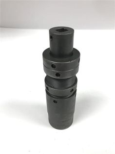 three black cylinders stacked on top of each other in the middle of a white background