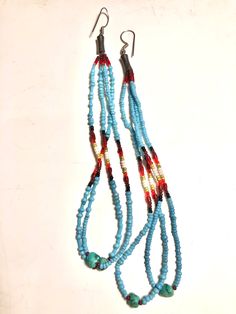 Hand Beaded turquoise white red maroon white black chartreuse seed beads with two pieces of  genuine turquoise strung at bottom of each earring. Made with Love. Silver ear wire. Enjoy 🖤❤️💛🤍 Artisan Turquoise Beaded Hand-strung Earrings, Blue Hand-strung Dangle Beaded Earrings, Turquoise Artisan Beaded Earrings, Artisan Hand-strung Beaded Earrings, Southwestern Dangling Beads For Jewelry Making, Blue Hand-strung Round Beads Earrings, Southwestern Blue Beaded Earrings With Round Beads, Blue Hand-strung Beaded Earrings, Colorful Southwestern Beaded Earrings