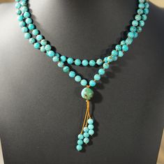 Authentic Turquoise Mala Necklace: 108 Beads for Peace & Tranquility Embrace inner peace and wisdom with this handcrafted turquoise mala necklace. Features: 108 genuine turquoise beads: Each bead hand-knotted for mindful meditation. Calming turquoise color: Evokes feelings of balance, peace, and inner strength. Durable nylon cord: Designed for long-lasting wear and comfort. Simple yet elegant beaded tassel: Adds a touch of tradition. Perfect for meditation, prayer, or everyday wear: Wear your in Spiritual Turquoise Necklace With Round Beads For Meditation, Turquoise Spiritual Necklaces With 8mm Beads, Turquoise Spiritual Beads For Meditation, Spiritual Turquoise Beads For Meditation, Spiritual Turquoise Necklace With Round Beads For Healing, Turquoise Beaded Necklace With 8mm Beads For Healing, Spiritual Turquoise Necklace With 8mm Beads, Turquoise Beaded Necklaces With 8mm Beads For Healing, Spiritual Turquoise Beaded Necklace With 108 Beads