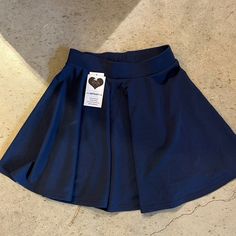 Navy Blue Tennis Skirt Never Worn Stretchy Waist Band Blue Stretch Mini Pleated Skirt, Blue Stretch Pleated Mini Skirt, Blue Pleated Flared Mini Skirt, Blue Pleated Flared Tennis Skirt, Blue Pleated Flared Skort, Casual Blue Full Pleated Skirt, Blue Lined Flared Tennis Skirt, Blue Stretch Flared Skort, Blue Stretch Flared Mini Skirt