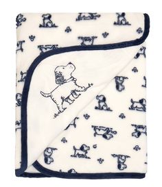 a white and blue blanket with dogs on it