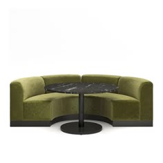 a green couch with a black table in front of it