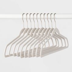 several white clothes hangers on a white rail