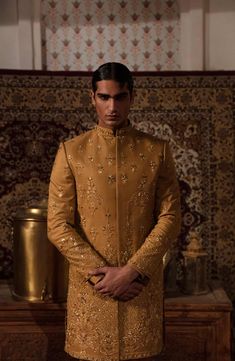 Classic Pakistani Men Sherwani and Trouser Groom Dress is a perfectly stitched masterpiece that gives the groom a magnificent look at the wedding. Premium fabric and embroidery make this beautiful Pakistani Groom Dress an epitome of beauty. Sherwani: Pakistani Groom Sherwani is embellished with graceful designs and embroidery work. Lavish details of tilla, sequins, and motifs enhance the royal look of this Sherwani Dress. Beaming fine details make this Sherwani your foremost priority for the big Pakistani Groom Dress, Sherwani Pakistani, Pakistani Men, Men Sherwani, Groom Sherwani, Groom Wedding Dress, Royal Look, Dresses Royal, Groom Wear