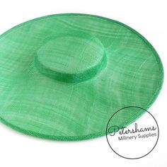 This emerald cartwheel hat base is a classic shape that has sprung into popularity in the past year. Made from 2 layers of stiffened sinamay, these cartwheels are ready to trim and are fitted with a petersham ribbon on the inside crown edge. Simply add a comb or headband to secure to the head.Hat base measures:Width: 35.5cm (14 inches)Crown Width: 13.5cm (5.3 inches)Crown Height: Approximately 3.5cm (1.7 inches)For even more millinery supplies you can find us here:www.etsy.com/shop/PetershamsAll Green Flat Cap For Spring, Green Flat Cap For Summer, Green Summer Flat Cap, Green Brimmed Straw Hat, Green Straw Hat With Short Brim, Green Wide Brim Fascinator For Kentucky Derby, Green Brimmed Sun Hat For Kentucky Derby, Green Short Brim Sun Hat For Kentucky Derby, Green Top Hat For Summer Church Events