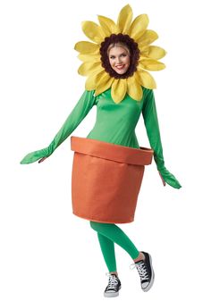 a woman dressed as a sunflower in a green dress and orange skirt with her hands on her hips