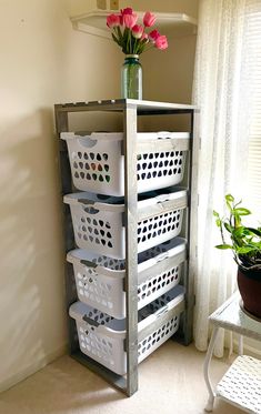 a shelf with baskets and flowers in it