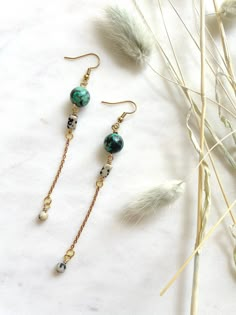 "These are long, beaded, dangle earrings featuring 10mm African Turquoise beads, brass chain, and rectangular Dalmatian Jasper beads. These unique boho earrings hang approximately 3.75\" inches from the lobe. The earwire is 18k gold plated and should be suitable if you have a metal allergy or sensitivity. These earrings are very lightweight and easy to wear. If you are not satisfied with your purchase, contact me within 14 days, and return your earrings in the original packaging for a full refun Turquoise Beaded Chain Drop Earrings, Bohemian Drop Earrings With Adjustable Chain, Turquoise Bohemian Earrings With Beaded Chain, Adjustable Beaded Chain Drop Earrings, Turquoise Earrings With Beaded Chain And Round Beads, Turquoise Earrings With Beaded Chain, Adjustable Dangle Earrings With Beaded Chain, Adjustable Beaded Chain Dangle Earrings, Afro Jewelry