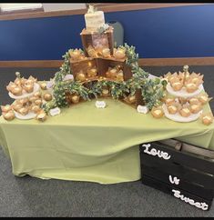 a table topped with lots of different types of cakes and desserts on top of it