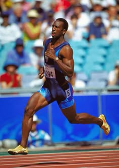 professional athlete running on the track in front of an audience