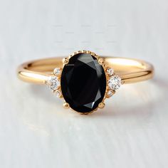 a black and white diamond ring on a white surface