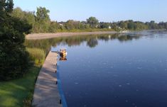 there is a boat that is sitting on the dock by the water's edge