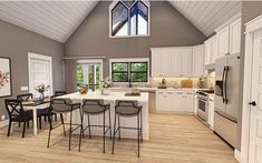 a large kitchen with white cabinets and wooden floors