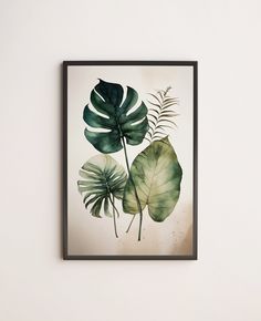 a green leaf print hanging on the wall