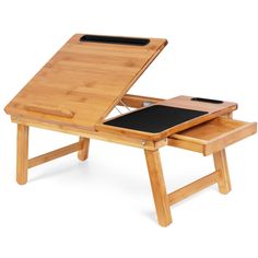 a wooden desk with a laptop on it and a mouse pad under the table top