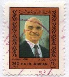 a postage stamp with an image of a man in a suit and tie on it