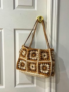 a crocheted purse hanging on a door handle