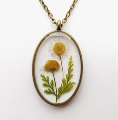 An unique handmade real pressed flower resin necklace. Do you love nature but too busy to get a real touch of it? Then this is the perfect piece of real flower necklace to reconnect you to mother nature! This necklace is created with pressed real wild daisy twig and lace fern leaves! Beautiful floral gifts of mother nature were carefully handcrafted to create unique design and embedded into high quality resin to provide everlasting value! Now set yourself free from the boredom of artificial urba Handmade Nature-inspired Necklaces For Mother's Day, Adjustable Birth Flower Necklace In Nature-inspired Style, Adjustable Nature-inspired Birth Flower Necklace, Nature-inspired Flower Necklace With Round Pendant, Nature-inspired Birth Flower Round Pendant Necklace, Bohemian Birth Flower Necklaces, Bohemian Birth Flower Pendant Necklace, Nature-inspired Round Pendant Flower Necklace, Nature-inspired White Necklace With Pressed Flowers