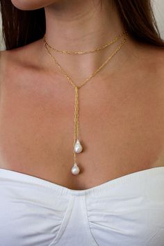 The Breathless Tie Lariat Necklace features a 36" signature brisbane chain with genuine baroque freshwater pearl ends. Designed to be worn different ways, wrap it twice and cross the ends or wear it long and cross the middle.  Lightweight and comfortable to wear.  Materials: 14K gold filled or sterling silver Closure: Beach Wedding Jewelry, Elizabeth Jewelry, Pearl Lariat Necklace, Minimal Jewelry, Lariat Necklace, Dainty Jewelry, Pretty Jewellery, Cute Jewelry, Pearl Jewelry