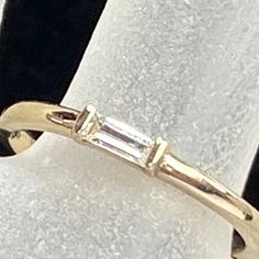 One Pretty 18k Yellow Gold Stackable Ring Band. It Tension Set A Straight Baguette, Approx. 5.0mm X 2.0mm, Weight 0.19ct, G Color And Vs1-Vs2 Clarity. Ring Top Is 2.4mm. Ring Size Is 6.5, (Resizable), Weight 1.9gm, Hallmark 18k 14k Gold Rings With Baguette Diamonds, Formal Yellow Gold Diamond Ring With Baguette Diamonds, Gold Baguette Rings For Formal Occasions, Gold Diamond Ring With Baguette Diamonds, Modern Baguette Diamond Ring In Yellow Gold, Gold Baguette Cut Diamond Ring, Timeless Gold Baguette Diamond Ring, Classic Gold Baguette Diamond Ring, Gold Baguette Diamond Ring For Formal Occasions