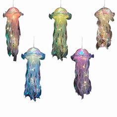 four different types of jellyfish hanging from strings on a white background in various colors