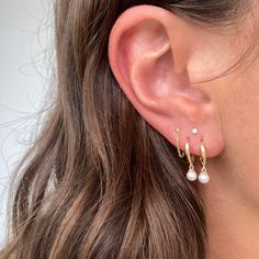 Take your earring game up a notch with these SADIE PEARL HUGGIES! These 14K gold huggie hoops, complete with little pearl drops, are dripping in fun and sophistication. Simply put, they'll set you apart - and you don't have to be a trendsetter to rock them. Sold as a pair! We make every effort to keep this style in stock but sometimes it does sell out! If that happens, please allow up to 6 weeks for us to make this just for you. If you need something by a specific date please do not hesitate to Pearl Huggies, Clean Sterling Silver, Vermeil Jewelry, Sell Out, Silver Pieces, Pure Gold, Pearl Drop, Jewelry Plate, Pure Silver