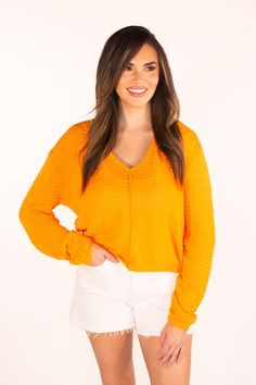 The Sweet Surprise Orange Light Weight Sweater has a bright and happy hue. With a relaxed fit and slightly sheer fabric, it's perfect to wear as we transition into spring. Just pair with a tank or bandeau underneath and you're ready to go. We recommend getting your true size Amanda is 5'3 and is wearing a size small Hand Wash Cold Hang to Dry 67% Polyester & 33% Cotton Spring Orange Stretch Tops, Chic Yellow Tops For Loungewear, Casual Orange Tops For Layering, Vibrant Relaxed Fit Tops, Trendy Orange Tops For Layering, Vibrant Cotton Tops For Spring, Vibrant Tops For Spring Day Out, Stretch Orange Top For Day Out, Stretch Orange Tops For Day Out