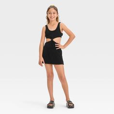 Your kiddo can layer their swimsuit while lounging on the beach or returning home from their swim session with this Solid Terry Cover-Up Dress from art class™. This sleeveless cover-up dress in a solid color features a center knot detail along with cutout sides and back for a stylish, breezy look. The cotton-blend terry fabric offers a cool and comfortable fit, while the pullover style allows for easy wear. Plus, the UPF 50+ rated finish offers added protection from UV rays. Welcome to art class Summer School Mini Dress, Casual Black Swim Dress, Playful Black Summer Dress, Sleeveless Summer School Dress, Summer Stretch Dresses For Playwear, Stretch Summer Dresses For Playwear, Stretch Dresses For Summer Playwear, Black Summer Beachwear Swimwear, Casual Sleeveless Swim Dress For Spring